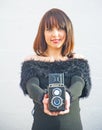 Girl with twin lens reflex camera.