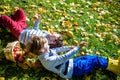 Girl and two boys lay on the grass and eat apples Royalty Free Stock Photo