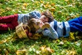 Girl and two boys lay on the grass and eat apples Royalty Free Stock Photo