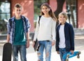 Girl and two boys with skateboards