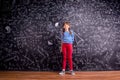 Girl with two braids, big blackboard with mathematical symbols