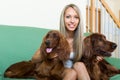 Girl with two Irish setters at home Royalty Free Stock Photo