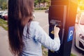 Girl types the text with her hands for making out the ticket for parking machine parking and payment for travel