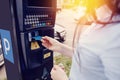 Girl types the text with her hands for making out the ticket for parking machine parking and payment for travel Royalty Free Stock Photo