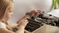 girl and typewriter.baby types.