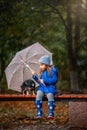 Girl with Chihuahua dog in autumn park