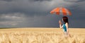 Girl with umbrella at field. Royalty Free Stock Photo