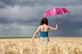 Girl with umbrella at field Royalty Free Stock Photo