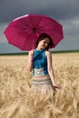 Girl with umbrella at field Royalty Free Stock Photo