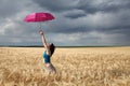 Girl with umbrella at field Royalty Free Stock Photo