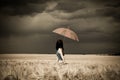 Girl with umbrella at field in retro style Royalty Free Stock Photo