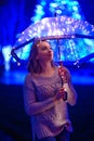 Girl with an umbrella in the night city with lights.Art photo Royalty Free Stock Photo