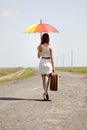 Girl with umbrella and suitcase Royalty Free Stock Photo