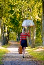 Girl with umbrella and suitcase in autumn park Royalty Free Stock Photo