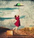 Girl with umbrella and suitcase at countryside Royalty Free Stock Photo