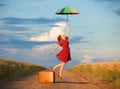 Girl with umbrella and suitcase Royalty Free Stock Photo