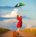 Girl with umbrella and suitcase Royalty Free Stock Photo