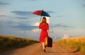 Girl with umbrella and suitcase Royalty Free Stock Photo