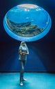 Girl under aquarium