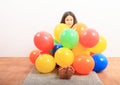 Girl under inflating balloons