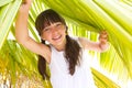 Girl under palm branch Royalty Free Stock Photo
