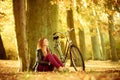 Girl under tree with bike. Royalty Free Stock Photo