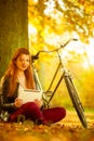 Girl under tree with bike Royalty Free Stock Photo