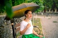 Girl under umbrella sitting on bench Royalty Free Stock Photo