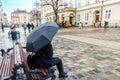 Girl under umbrella sitting on the bench Royalty Free Stock Photo