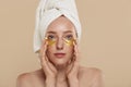 Girl with undereye patches and towel on head Royalty Free Stock Photo