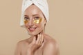 Girl with undereye patches and towel on head Royalty Free Stock Photo