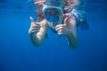 Girl underwater showing thumbs. Snorkeling woman in full face mask. Royalty Free Stock Photo