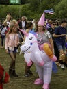 A girl in a unicorn costume at a festival