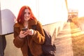 A portrait of a happy female college student using smartphone at campus. Royalty Free Stock Photo