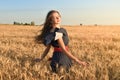 The girl with the unraveling hair spins in the field