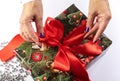The girl unties the bow on the gift box. The concept of the new year holiday