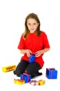 Girl is unwrapping her presents Royalty Free Stock Photo