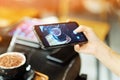 A girl used her smartphone for take a picture on coffee cafe Royalty Free Stock Photo