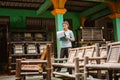 girl uses a clipboard to check the number of chairs