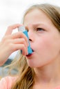 Girl uses an inhaler during an asthma attack Royalty Free Stock Photo