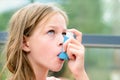 Girl uses an inhaler during an asthma attack Royalty Free Stock Photo