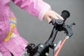 The girl uses a signal on a child`s Bicycle