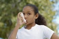 Girl Using Asthma Inhaler Royalty Free Stock Photo