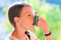 Girl using asthma inhaler Royalty Free Stock Photo