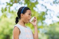 Girl using an asthma inhaler Royalty Free Stock Photo