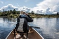 Girl using binocular on Canoe lake of two rivers in the algonquin national park in Ontario Canada on sunny cloudy day Royalty Free Stock Photo