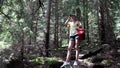 Girl Using Binoculars in Mountains Forest, Kid Hiking at Camping, Wood Alpine Trails, Child Traveling in Adventure Trip Vacation