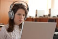 Girl is using computer with headphones Royalty Free Stock Photo