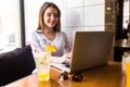 Girl using laptop and drink fresh at cafe Royalty Free Stock Photo