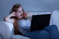 Girl using laptop and eating watermelon Royalty Free Stock Photo